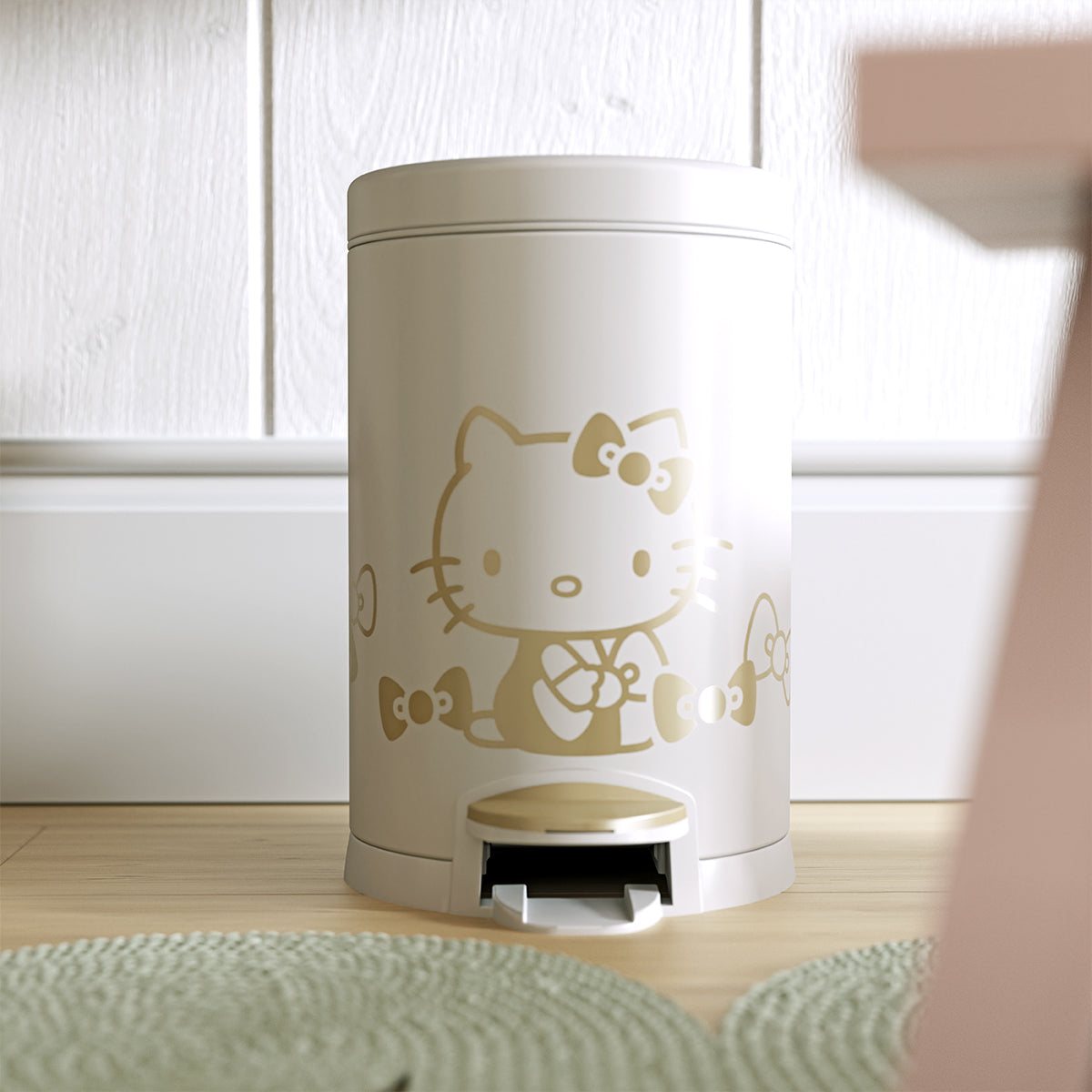 Lifestyle view of Simplehuman 4.5L Round Step Can, White with Gold Hello Kitty graphic, compact for kids' rooms, hands-free pedal.