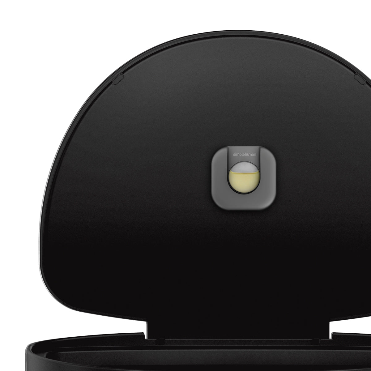 Detail view of Simplehuman 45L Step Can lid, Matte Black, showing replaceable odorsorb pod feature.