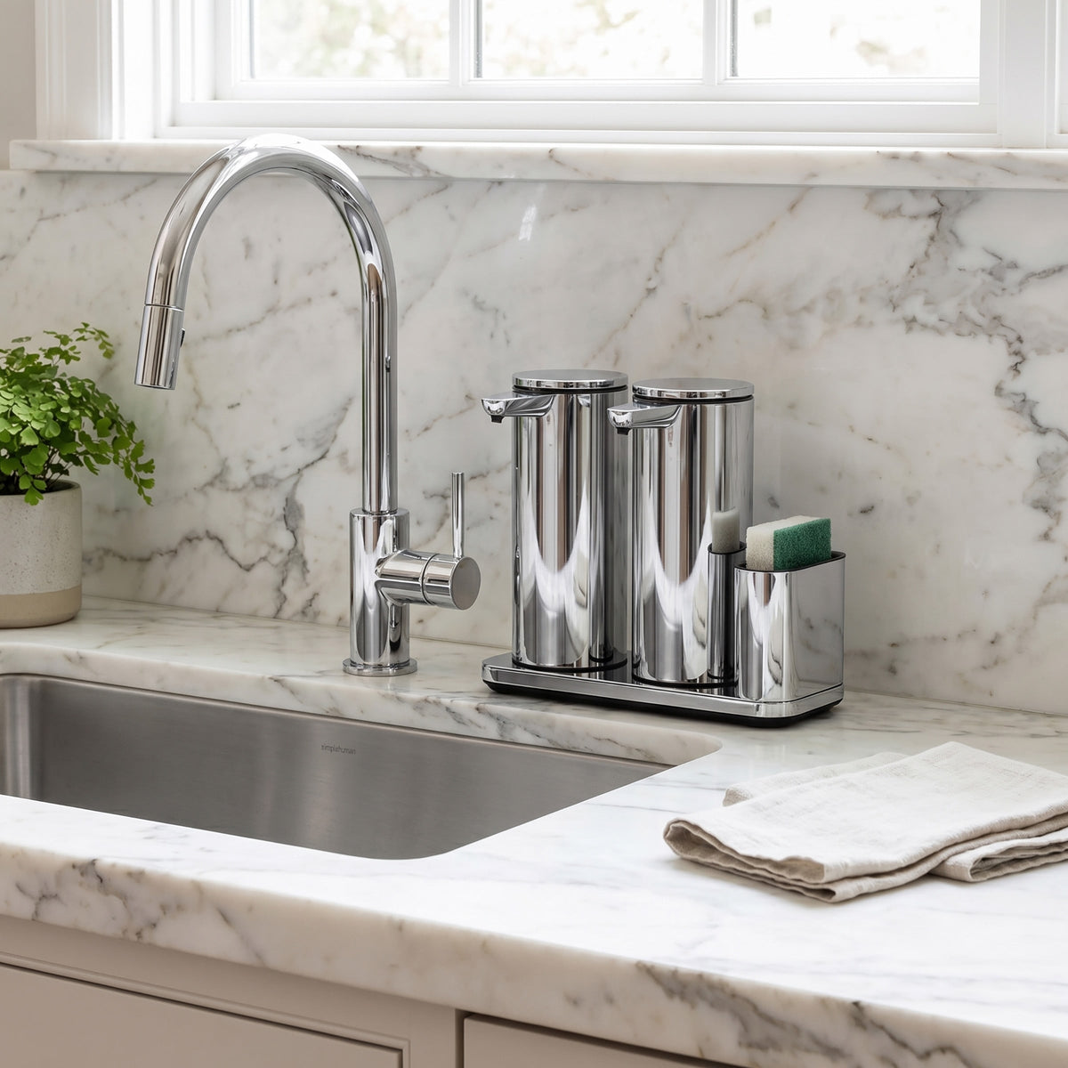 Simplehuman's Dual 14 oz. Sensor Pump in Polished in a modern kitchen setting with marble counter top.